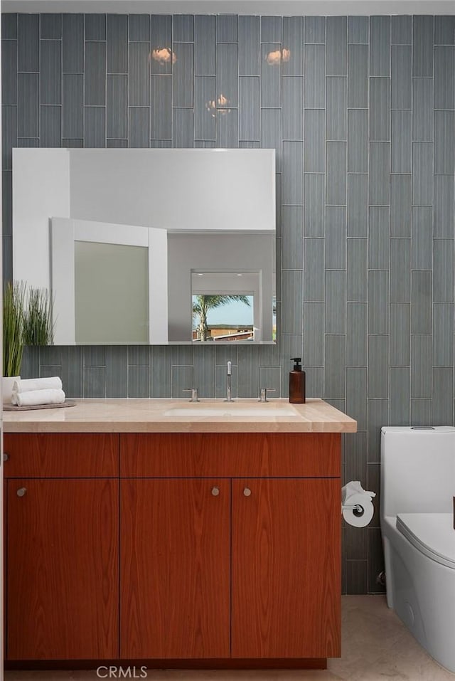 1119 Katella St, Laguna Beach, CA 92651 - bathroom with tile walls, vanity, toilet, and tile patterned floors
