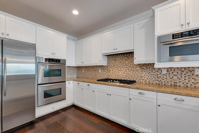 1539 Windshore Way, Oxnard, CA 93035 - kitchen with appliances with stainless steel finishes, dark wood-style flooring, white cabinetry, backsplash, and recessed lighting