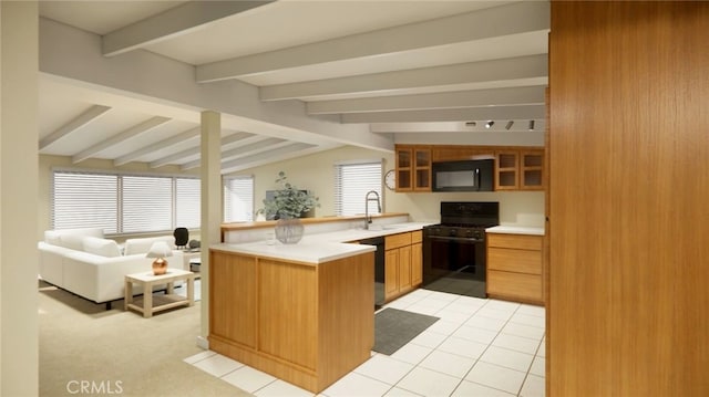 2468 Silverstrand Ave, Hermosa Beach, CA 90254 - kitchen with black appliances, a peninsula, glass insert cabinets, light countertops, and open floor plan
