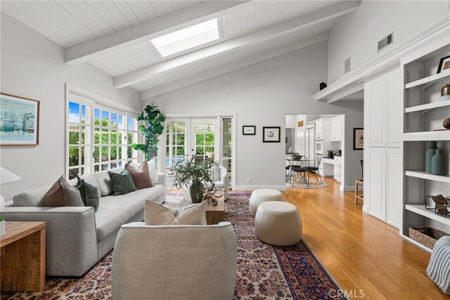 1162 Castlegate, North Tustin, CA 92705 - living area with light wood-style floors, a skylight, high vaulted ceiling, french doors, and wooden ceiling with exposed beams