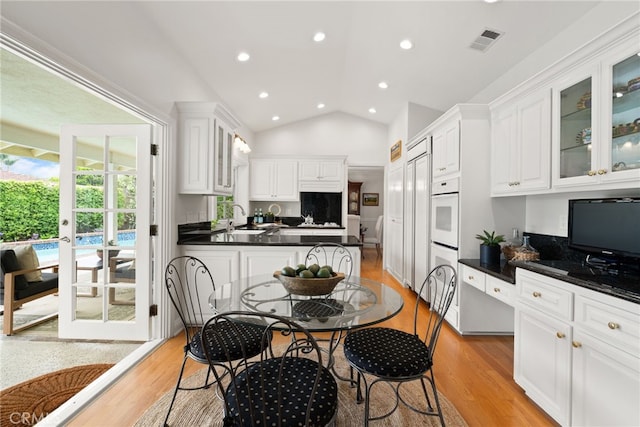 1162 Castlegate, North Tustin, CA 92705 - kitchen with a sink, light wood-type flooring, lofted ceiling, dark countertops, and white cabinets