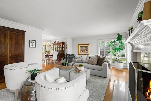 1162 Castlegate, North Tustin, CA 92705 - living room featuring a chandelier, crown molding, and light wood finished floors