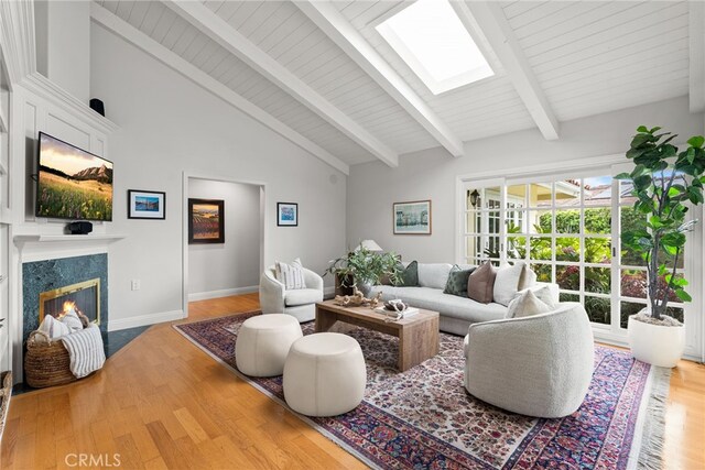 1162 Castlegate, North Tustin, CA 92705 - living area with wood finished floors, a fireplace, a skylight, and baseboards