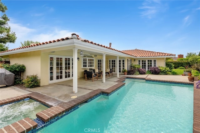 1162 Castlegate, North Tustin, CA 92705 - rear view of property with french doors, an in-ground hot tub, stucco siding, an outdoor pool, and a patio area