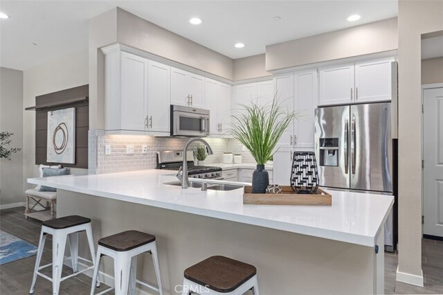 78 Patria, Rancho Mission Viejo, CA 92694 - kitchen featuring stainless steel appliances, a peninsula, white cabinets, light countertops, and recessed lighting