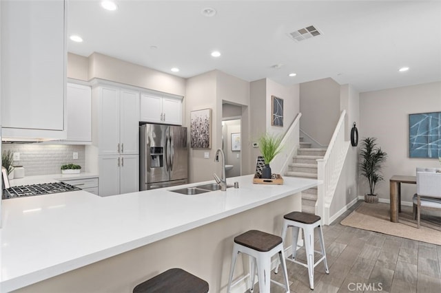 78 Patria, Rancho Mission Viejo, CA 92694 - kitchen featuring stainless steel fridge, light wood-style floors, a breakfast bar, recessed lighting, and backsplash