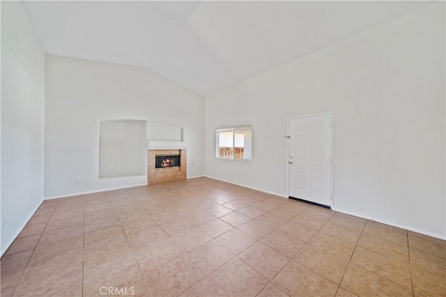 26577 Trumble Rd, Menifee, CA 92585 - unfurnished living room with a tiled fireplace, light tile patterned floors, and high vaulted ceiling