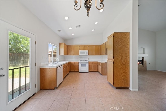 26577 Trumble Rd, Menifee, CA 92585 - kitchen with white appliances, healthy amount of natural light, lofted ceiling, light countertops, and light tile patterned floors