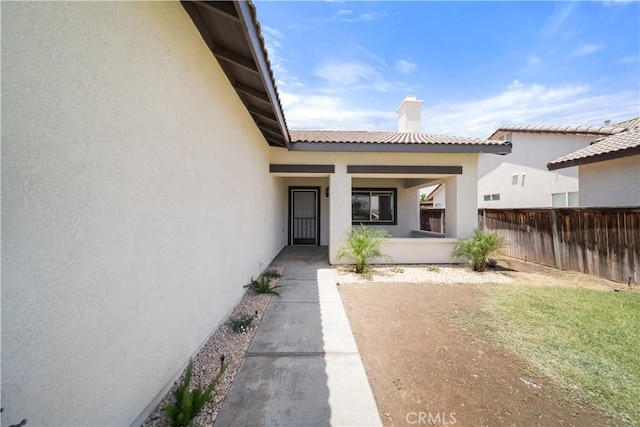 26577 Trumble Rd, Menifee, CA 92585 - entrance to property featuring a chimney, stucco siding, and covered porch