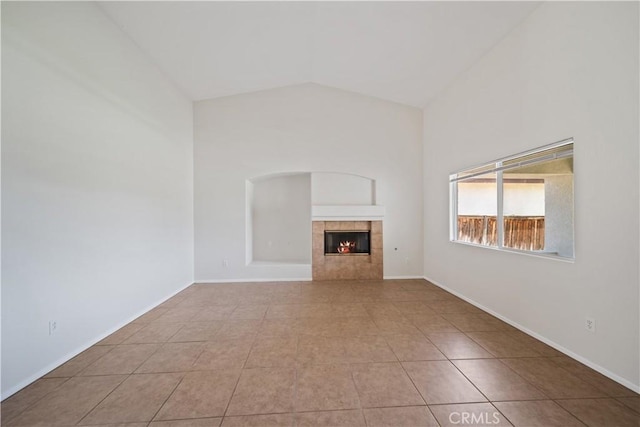 26577 Trumble Rd, Menifee, CA 92585 - unfurnished living room featuring tile patterned flooring, a tiled fireplace, and vaulted ceiling