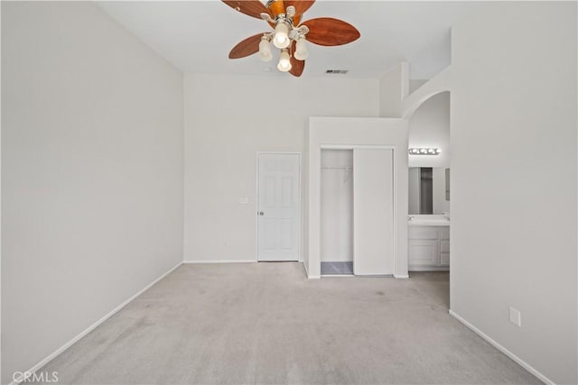 26577 Trumble Rd, Menifee, CA 92585 - unfurnished bedroom with carpet, a closet, arched walkways, and a ceiling fan