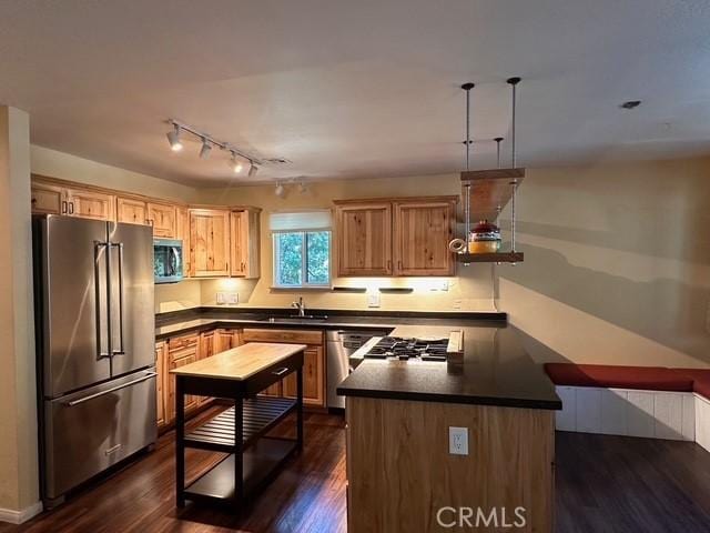 41141 Oak Dr, Forest Falls, CA 92339 - kitchen featuring stainless steel appliances, dark countertops, and dark wood-style flooring