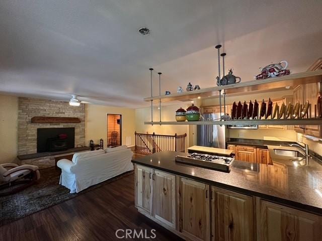 41141 Oak Dr, Forest Falls, CA 92339 - kitchen with a sink, dark countertops, stainless steel gas stovetop, and dark wood-style floors