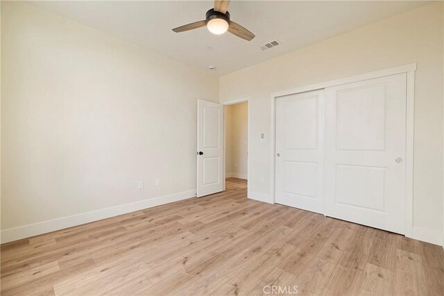 2395 Tokay Ct, Paradise, CA 95969 - unfurnished bedroom featuring light wood finished floors, baseboards, a closet, and a ceiling fan