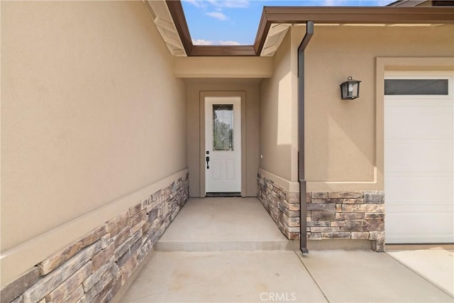 2395 Tokay Ct, Paradise, CA 95969 - property entrance with stucco siding, stone siding, and an attached garage