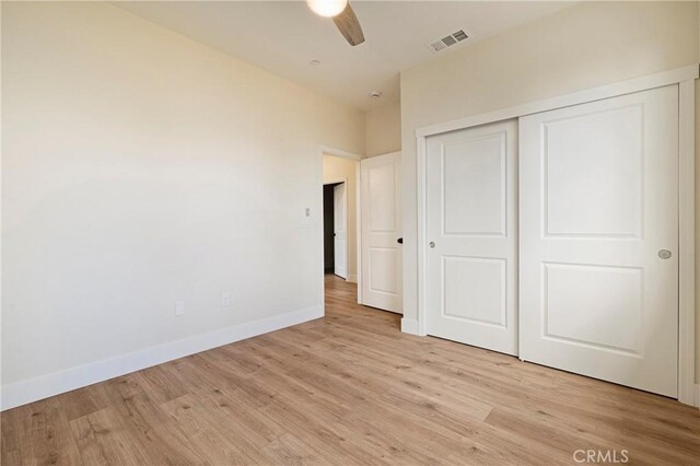 2395 Tokay Ct, Paradise, CA 95969 - unfurnished bedroom with light wood finished floors, baseboards, a closet, and a ceiling fan