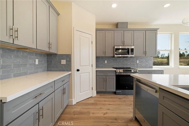 2395 Tokay Ct, Paradise, CA 95969 - kitchen with stainless steel appliances, gray cabinetry, light wood-style flooring, and recessed lighting