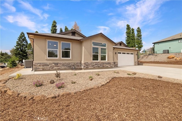 2395 Tokay Ct, Paradise, CA 95969 - view of front of home with stucco siding, driveway, stone siding, and an attached garage