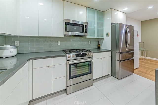 4813 Oakwood Ave Unit 201, Los Angeles, CA 90004 - kitchen with stainless steel appliances, white cabinetry, modern cabinets, backsplash, and recessed lighting