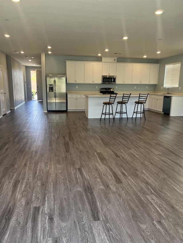 32323 Roman Warren Way, Winchester, CA 92596 - kitchen featuring appliances with stainless steel finishes, light countertops, dark wood-style flooring, white cabinets, and recessed lighting