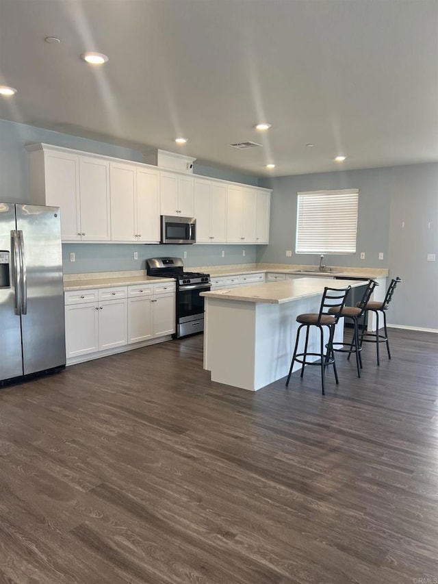 32323 Roman Warren Way, Winchester, CA 92596 - kitchen with stainless steel appliances, light countertops, white cabinets, dark wood-style floors, and recessed lighting