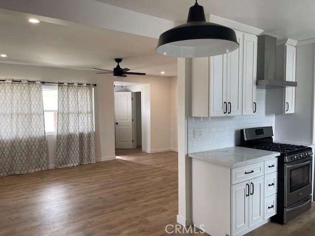 21329 Jaffrey Ave, Torrance, CA 90502 - kitchen with gas range, wall chimney exhaust hood, white cabinets, decorative backsplash, and dark wood-style flooring