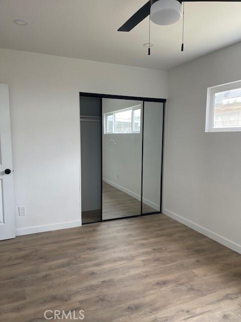 21329 Jaffrey Ave, Torrance, CA 90502 - unfurnished bedroom featuring baseboards, wood finished floors, a closet, and a ceiling fan