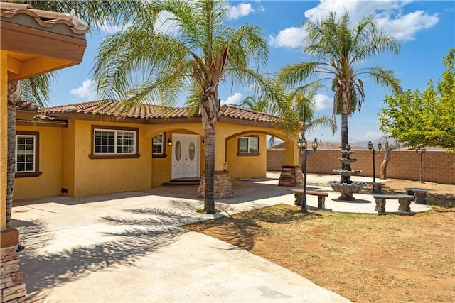 5071 Bushnell Ave, Riverside, CA 92505 - view of front of property featuring stucco siding, a patio area, and a tile roof