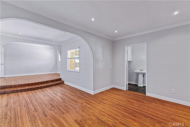 5071 Bushnell Ave, Riverside, CA 92505 - spare room with arched walkways, wood finished floors, crown molding, and recessed lighting