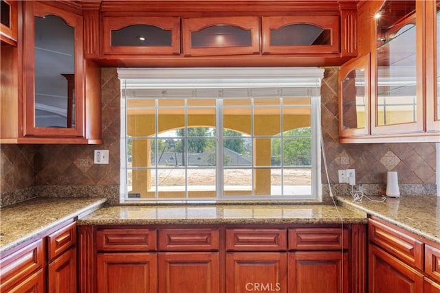 5071 Bushnell Ave, Riverside, CA 92505 - kitchen featuring decorative backsplash, glass insert cabinets, and light stone counters