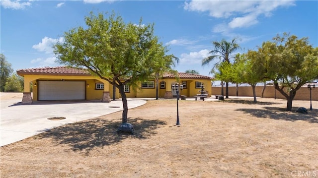 5071 Bushnell Ave, Riverside, CA 92505 - mediterranean / spanish-style house with a tiled roof, a garage, stucco siding, and concrete driveway