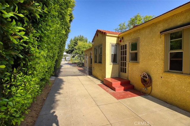 1321 Virginia Ave, Glendale, CA 91202 - view of side of home featuring stucco siding and a gate
