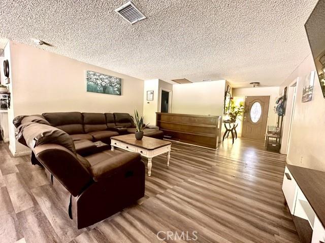 3346 Sunnyside Dr, Riverside, CA 92506 - living room featuring wood finished floors and a textured ceiling