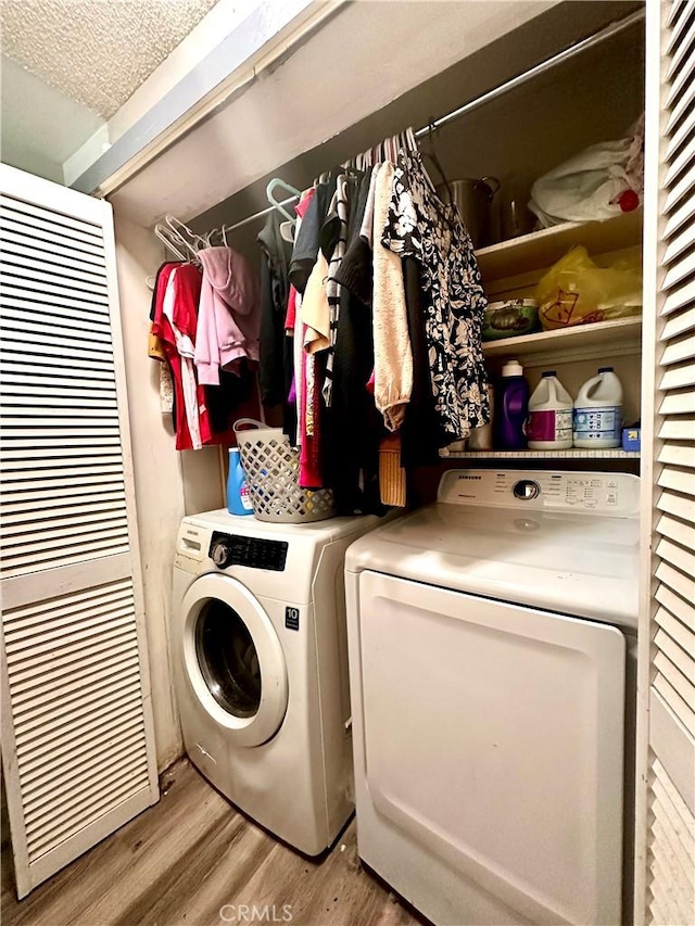 3346 Sunnyside Dr, Riverside, CA 92506 - washroom featuring washer and dryer, wood finished floors, a heating unit, and a textured ceiling