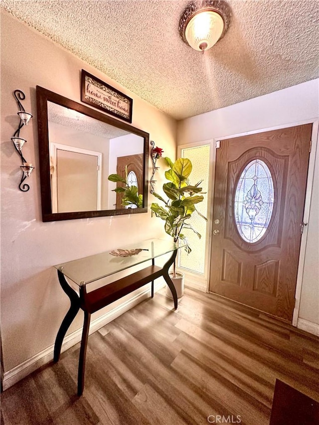 3346 Sunnyside Dr, Riverside, CA 92506 - foyer featuring a textured ceiling, wood finished floors, and baseboards
