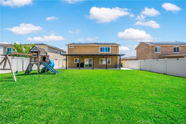 29377 Wyatt Earp Way, Winchester, CA 92596 - back of house featuring solar panels, a patio, a playground, a ceiling fan, and stucco siding