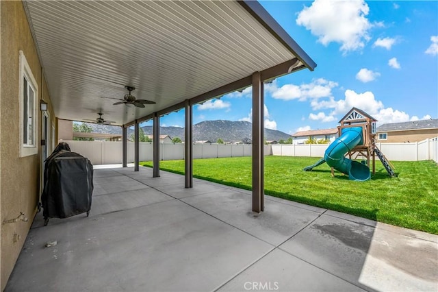 29377 Wyatt Earp Way, Winchester, CA 92596 - view of patio with a playground, a ceiling fan, a mountain view, and grilling area