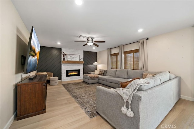 29377 Wyatt Earp Way, Winchester, CA 92596 - living area with ceiling fan, light wood-style floors, baseboards, a large fireplace, and an accent wall