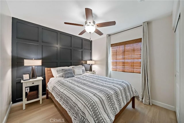 29377 Wyatt Earp Way, Winchester, CA 92596 - bedroom featuring a decorative wall, light wood-type flooring, baseboards, and a ceiling fan