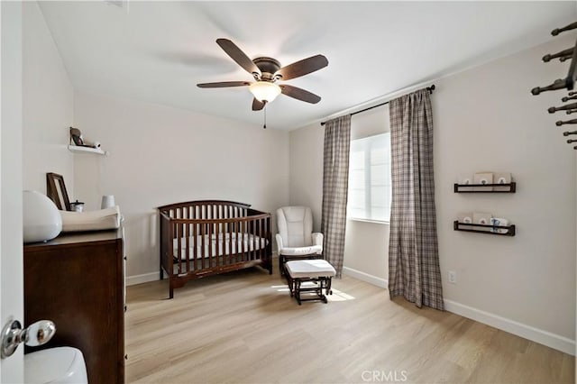 29377 Wyatt Earp Way, Winchester, CA 92596 - bedroom with wood finished floors, baseboards, a nursery area, and ceiling fan