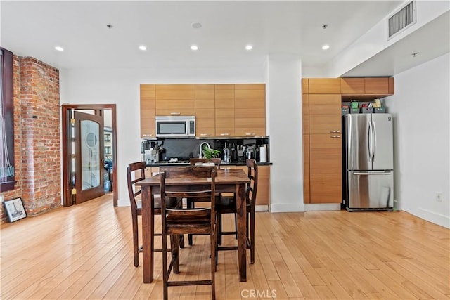 460 S Spring St Unit 613, Los Angeles, CA 90013 - dining space with light wood finished floors, baseboards, and recessed lighting