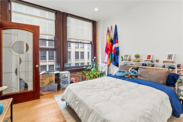 460 S Spring St Unit 613, Los Angeles, CA 90013 - bedroom with wood-type flooring, floor to ceiling windows, and recessed lighting
