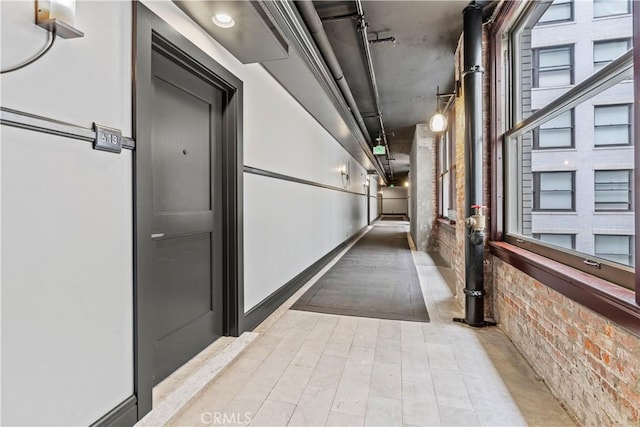 460 S Spring St Unit 613, Los Angeles, CA 90013 - corridor featuring brick wall and wood finished floors