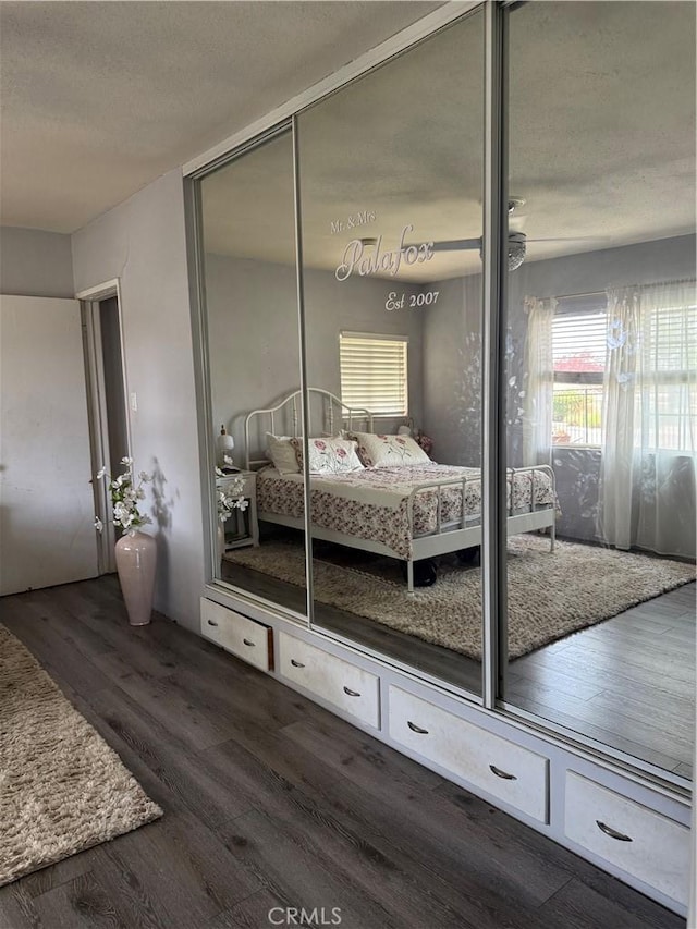 6867 Weaver St, Riverside, CA 92504 - bedroom with dark wood-style flooring, a textured ceiling, and a closet