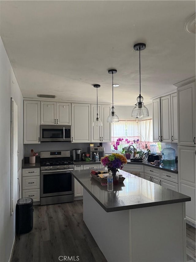 6867 Weaver St, Riverside, CA 92504 - kitchen featuring appliances with stainless steel finishes, white cabinetry, and dark wood-style floors