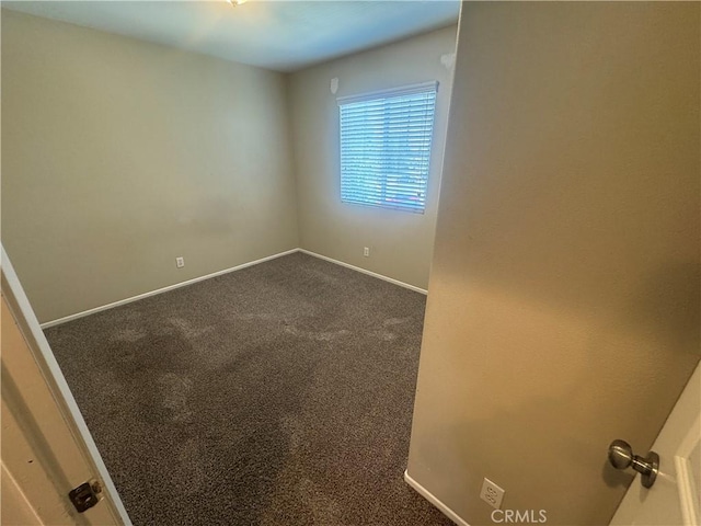 9757 Edenbrook Dr, Riverside, CA 92503 - unfurnished room with dark colored carpet and baseboards