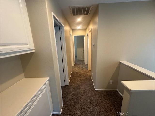 9757 Edenbrook Dr, Riverside, CA 92503 - corridor with dark colored carpet and baseboards