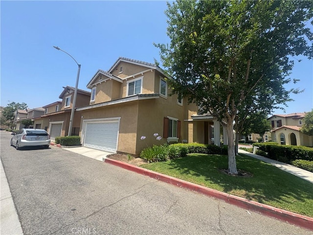 9757 Edenbrook Dr, Riverside, CA 92503 - view of front of house with stucco siding, driveway, and a front lawn