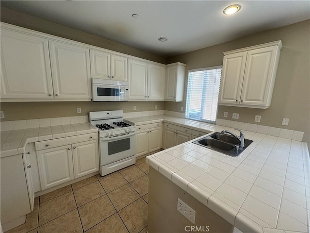 9757 Edenbrook Dr, Riverside, CA 92503 - kitchen with white appliances, a sink, tile counters, white cabinets, and light tile patterned floors