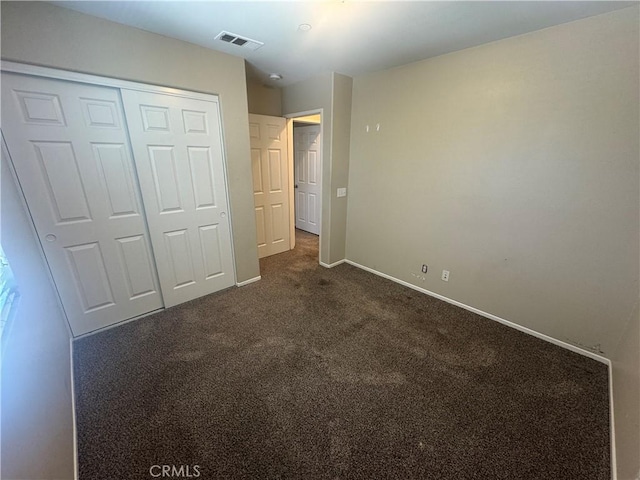 9757 Edenbrook Dr, Riverside, CA 92503 - unfurnished bedroom with dark carpet, a closet, and baseboards